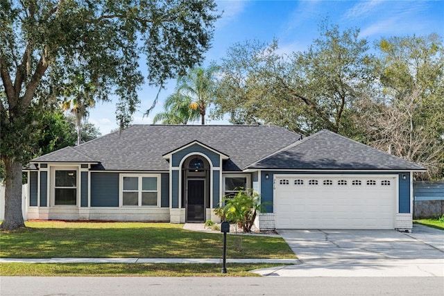 ranch-style home featuring a garage and a front yard