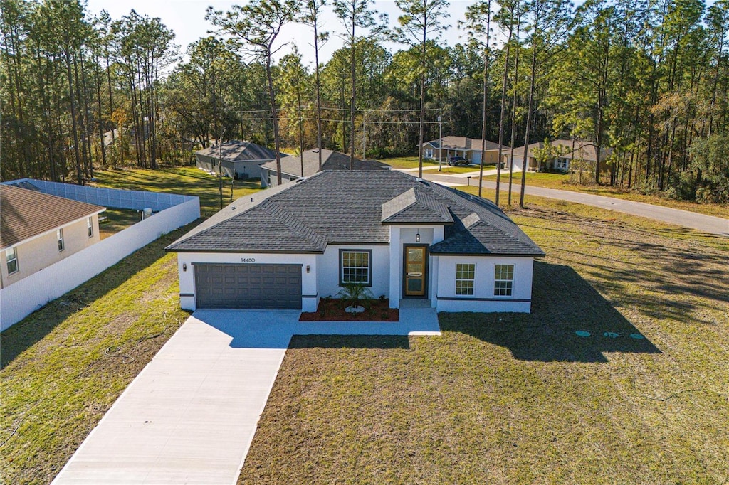 view of front of home with a garage and a front lawn