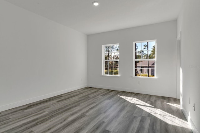 unfurnished room with hardwood / wood-style flooring