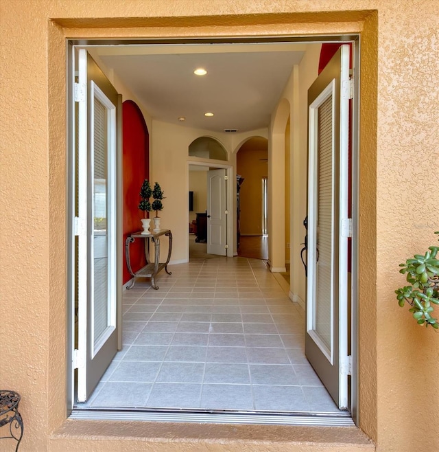 hall with light tile patterned floors