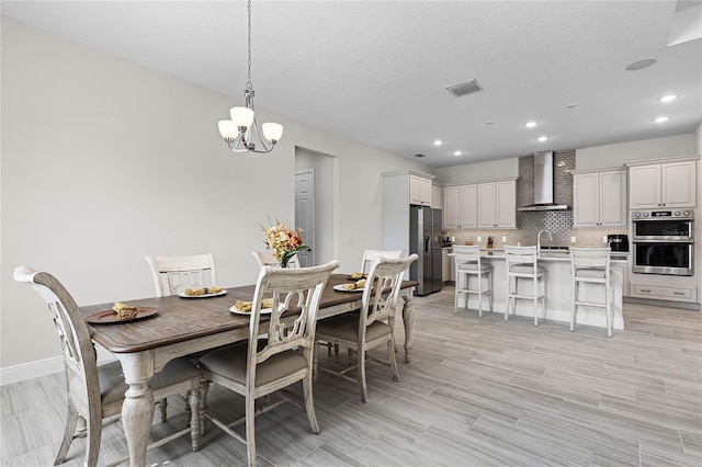 8456 Norwich Way, Mount Dora, FL 32757 - dining area with a chandelier, recessed lighting, baseboards, and light wood-style flooring