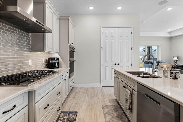 8456 Norwich Way, Mount Dora, FL 32757 - kitchen featuring appliances with stainless steel finishes, wall chimney exhaust hood, a sink, tasteful backsplash, and recessed lighting
