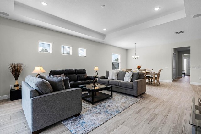 8456 Norwich Way, Mount Dora, FL 32757 - living area featuring a tray ceiling, recessed lighting, baseboards, and light wood-style flooring