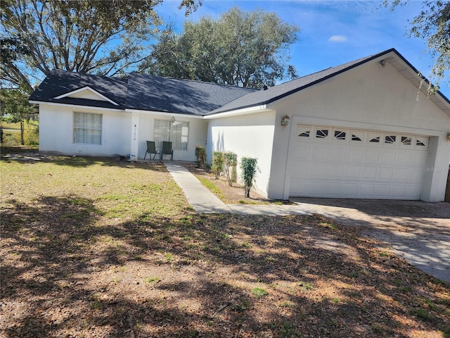 single story home featuring a garage and a front yard