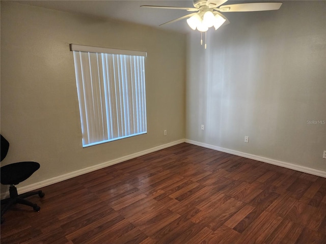 spare room featuring dark wood-type flooring and ceiling fan