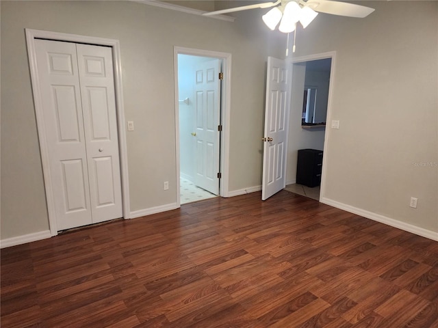 unfurnished bedroom featuring dark hardwood / wood-style floors, ceiling fan, and ensuite bath