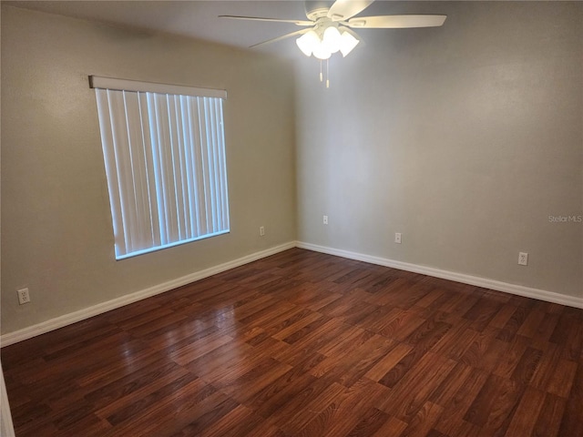 empty room with ceiling fan and dark hardwood / wood-style floors