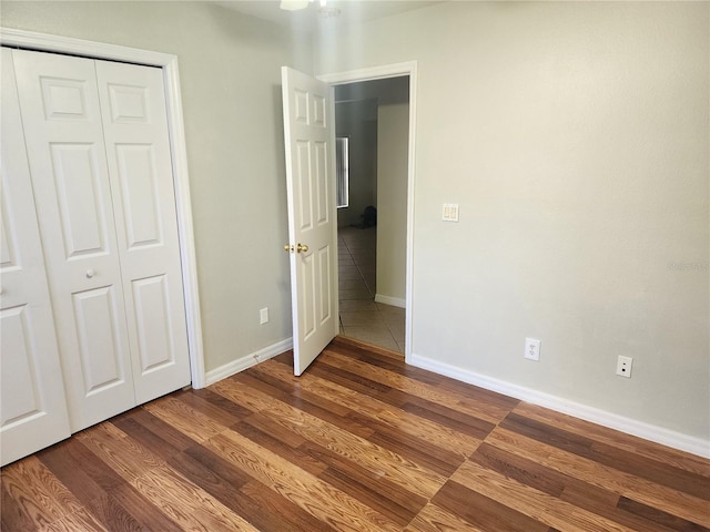 unfurnished bedroom with wood-type flooring and a closet