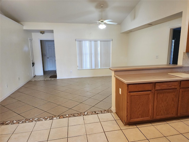 kitchen with lofted ceiling, light tile patterned floors, and ceiling fan