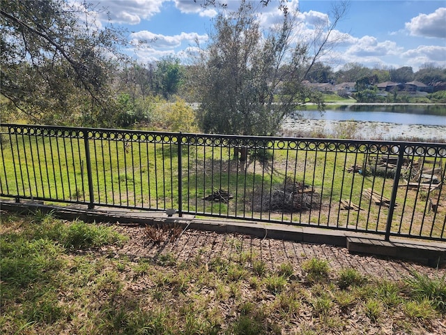 exterior space with a lawn and a water view