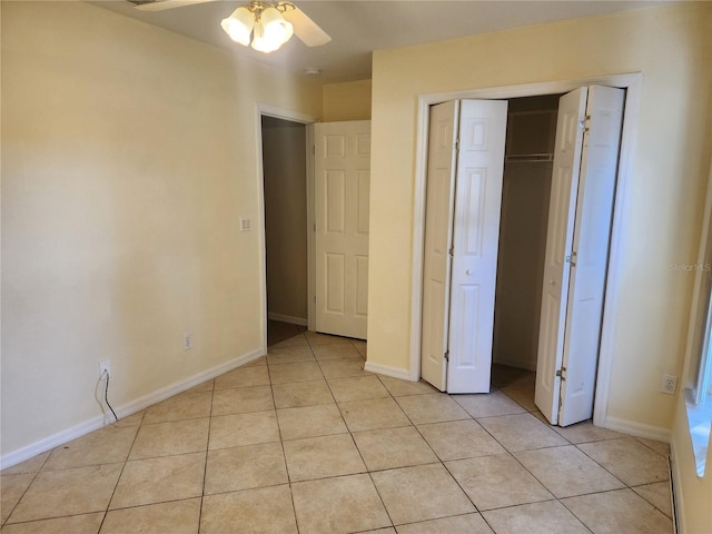 unfurnished bedroom with light tile patterned flooring, ceiling fan, and a closet