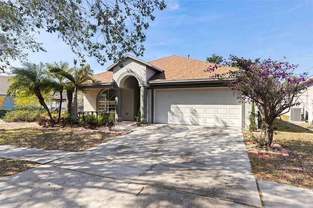 ranch-style house featuring central AC and a garage