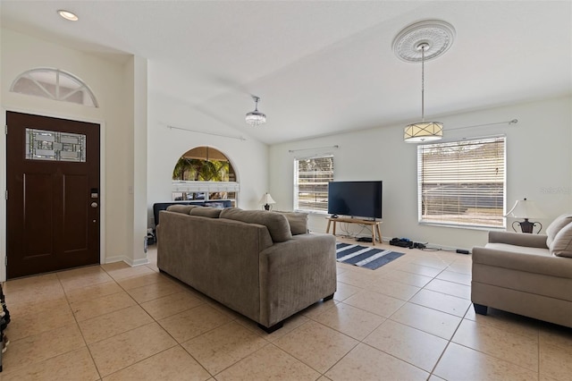 tiled living room with vaulted ceiling and plenty of natural light