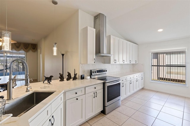 kitchen featuring sink, white cabinetry, decorative light fixtures, electric stove, and wall chimney range hood