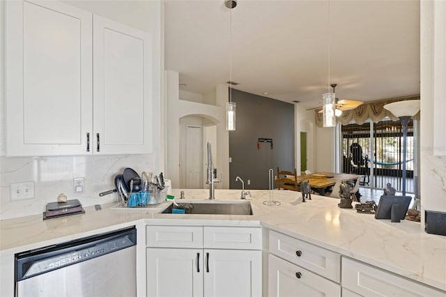 kitchen featuring white cabinetry, hanging light fixtures, light stone counters, and dishwasher