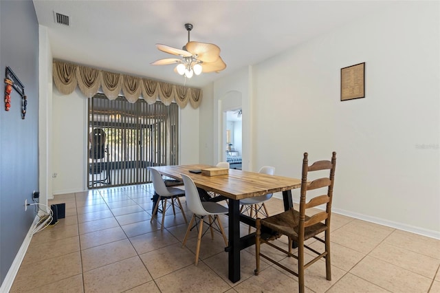 tiled dining room featuring ceiling fan