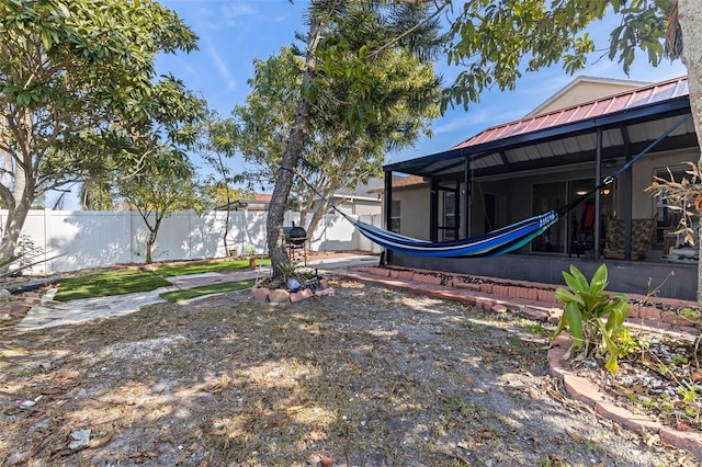 view of yard with glass enclosure