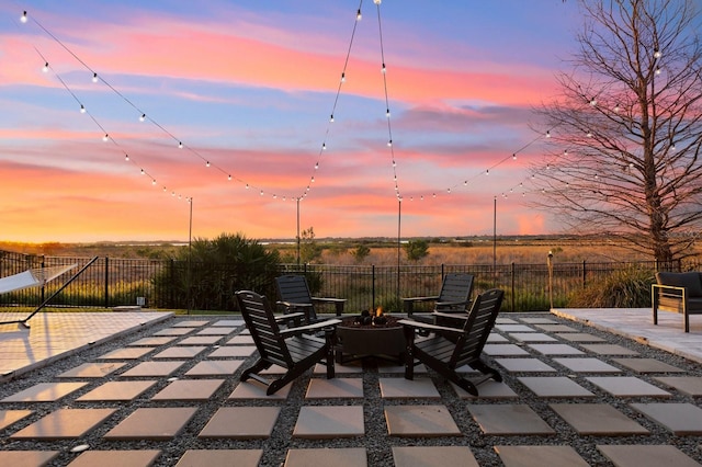 patio terrace at dusk with fence and a fire pit