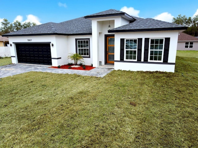 prairie-style home featuring a garage and a front lawn