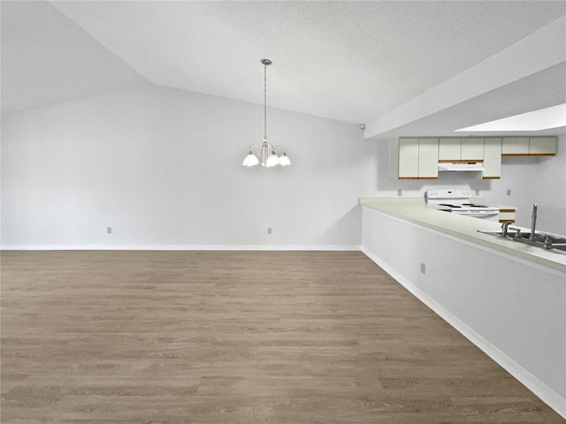 kitchen with white electric range, lofted ceiling, sink, hardwood / wood-style flooring, and hanging light fixtures