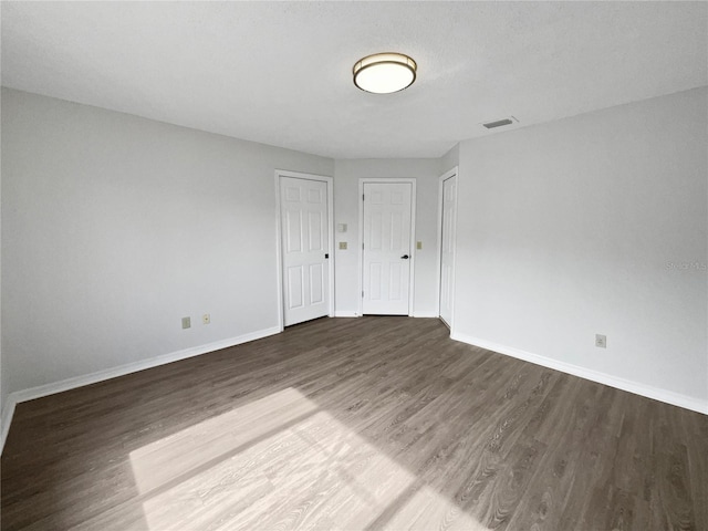 unfurnished room featuring dark hardwood / wood-style floors