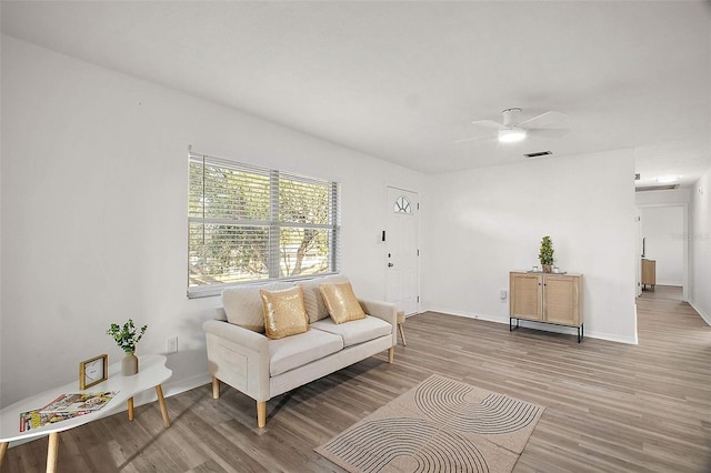 living room with ceiling fan and hardwood / wood-style floors