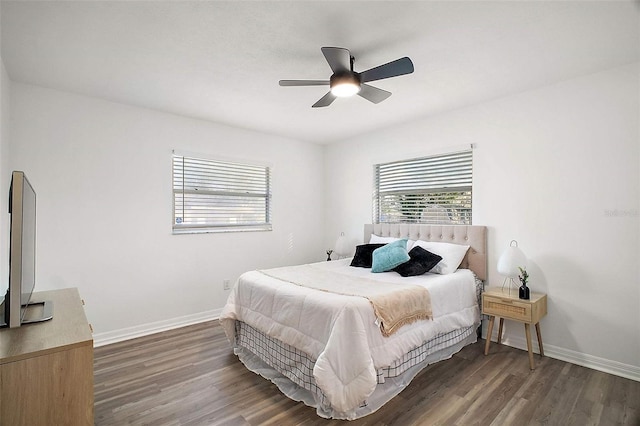 bedroom with multiple windows, dark hardwood / wood-style flooring, and ceiling fan