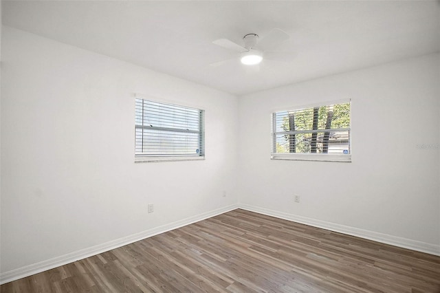 empty room featuring dark hardwood / wood-style floors and ceiling fan