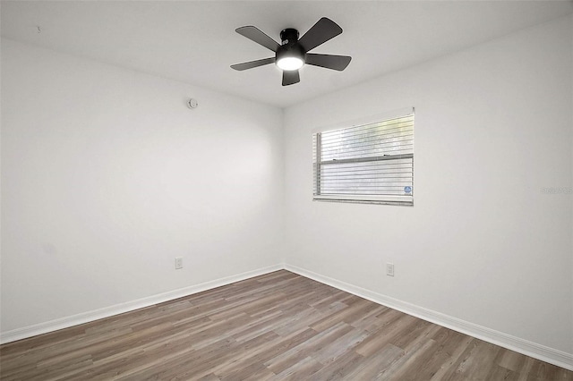 spare room with hardwood / wood-style floors and ceiling fan