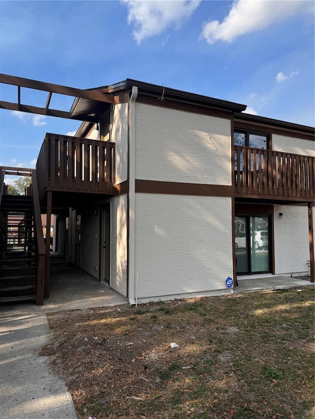 back of property featuring a deck