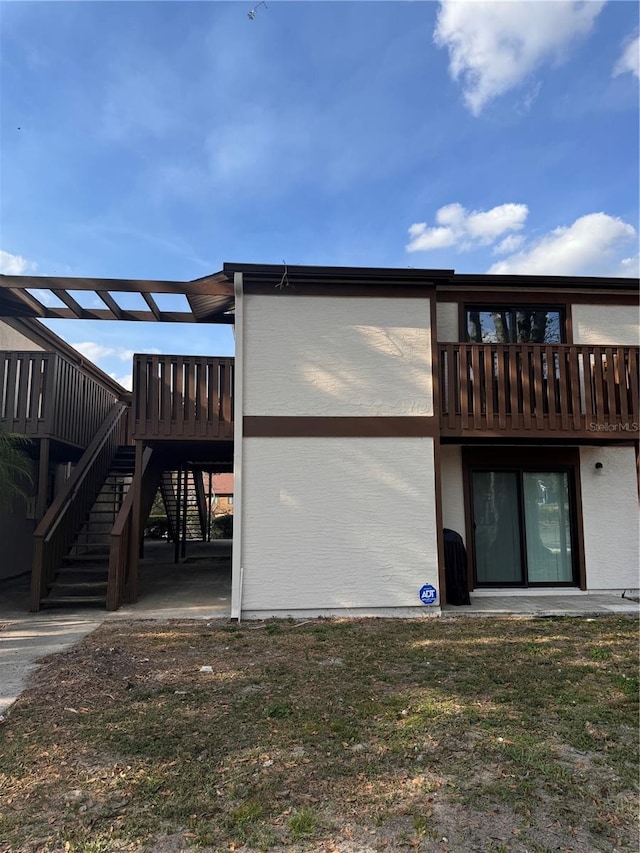 rear view of property featuring a deck