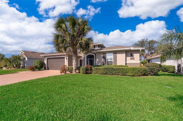 view of front facade with a garage and a front lawn