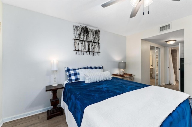 bedroom featuring ceiling fan, wood-type flooring, and connected bathroom