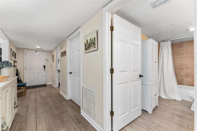 corridor with a textured ceiling