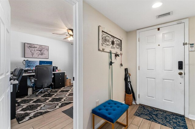 entryway featuring ceiling fan