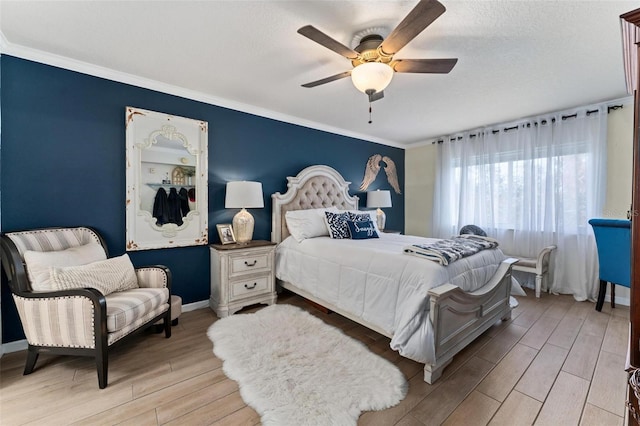 bedroom with crown molding, light hardwood / wood-style flooring, a textured ceiling, and ceiling fan