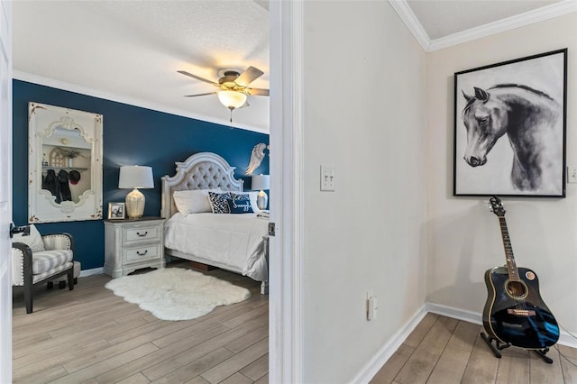 bedroom with crown molding, ceiling fan, and light hardwood / wood-style floors