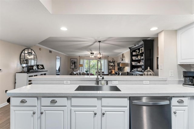 kitchen with white cabinetry, dishwasher, sink, ornamental molding, and kitchen peninsula