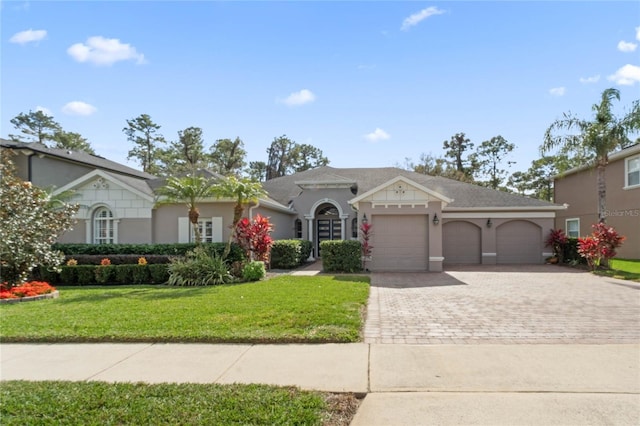 single story home featuring a garage and a front yard