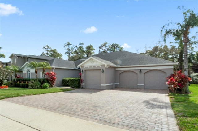 view of front of property featuring a garage and a front lawn