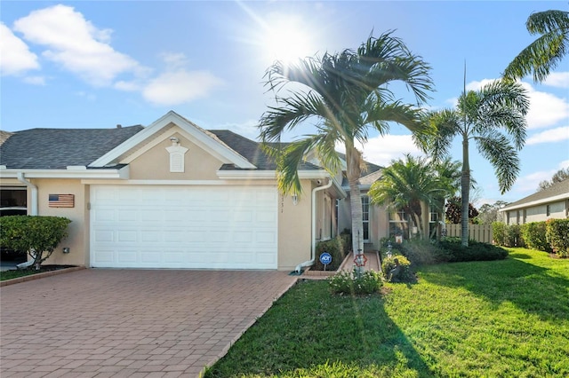 ranch-style house with a garage and a front lawn