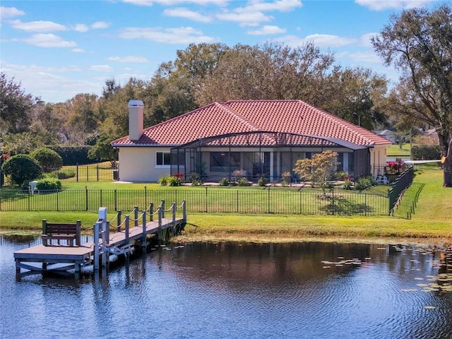 view of dock featuring a water view, a yard, and a lanai