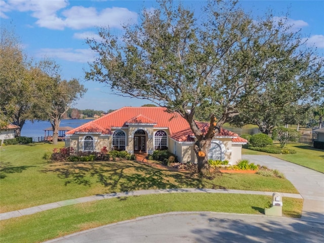 mediterranean / spanish-style home featuring a front yard