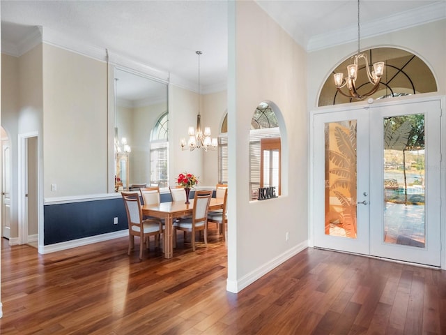 interior space with a notable chandelier, dark hardwood / wood-style floors, and french doors