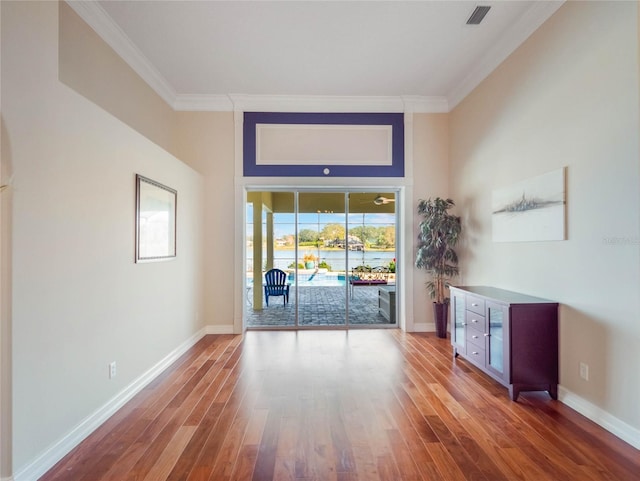 interior space featuring hardwood / wood-style floors and crown molding