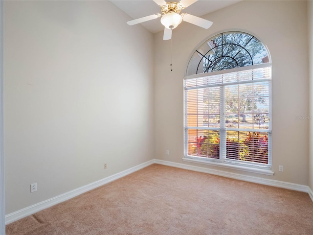 unfurnished room with light carpet, a wealth of natural light, and ceiling fan