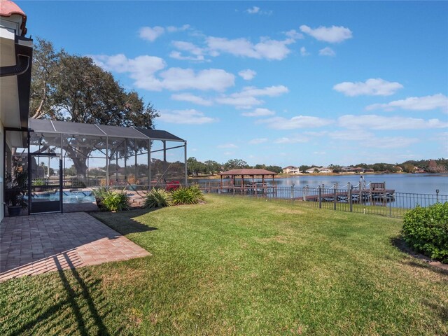 view of yard featuring a water view, a lanai, and a patio