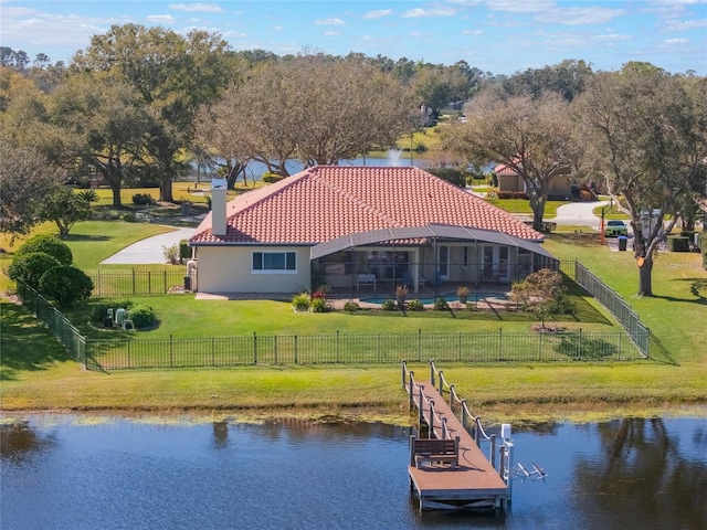 exterior space featuring a water view, a lanai, and a lawn