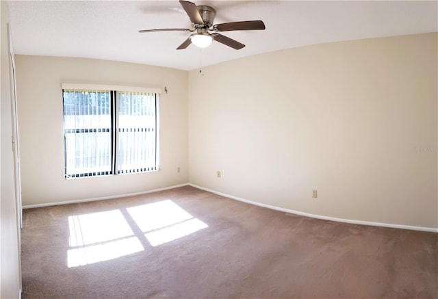 carpeted spare room featuring ceiling fan