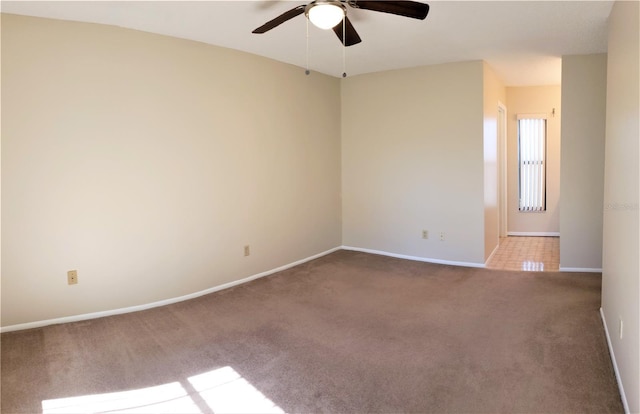 spare room featuring carpet and ceiling fan